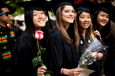 Graduates Cary Lin (from left), Paige Holtzman, Cindy Cheng, and Diane Choi pause for a photograph while processing into Tercentenary Theatre during the Morning Exercises. 