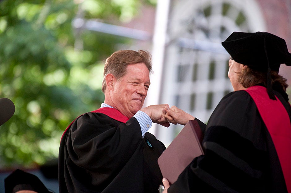Comedian Jimmy Tingle, who delivered the Graduate English Address, bumps fists with University Marshal Jackie O'Neill.  Jon Chase/Harvard Staff Photographer