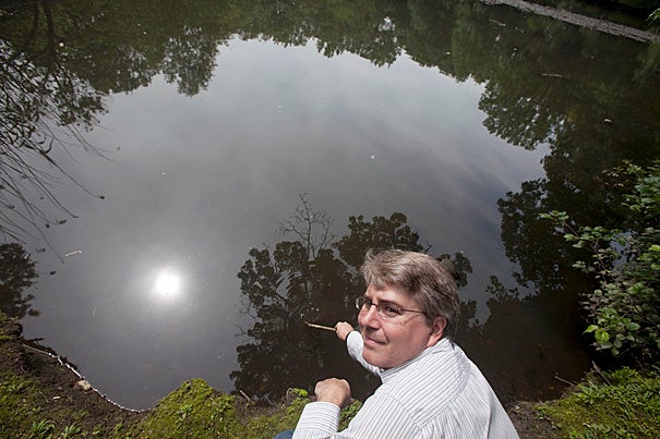 James Shine, Harvard senior lecturer on aquatic chemistry, shows what pollution has done to Boston's Muddy River.
