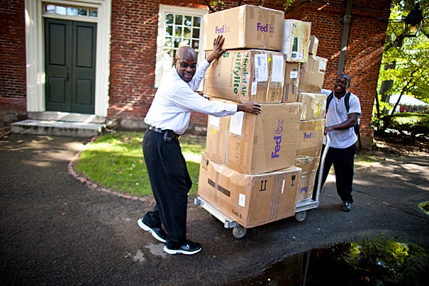 Freshman Terrance Moore (right) and his father Melvin move Terrance's boxes past Massachusetts Hall and into Straus Hall where Terrance will join the Class of 2014.