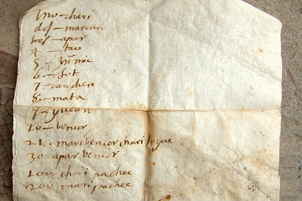 The back side of an early 17th century letter shows translations for numbers from Spanish to a lost language.