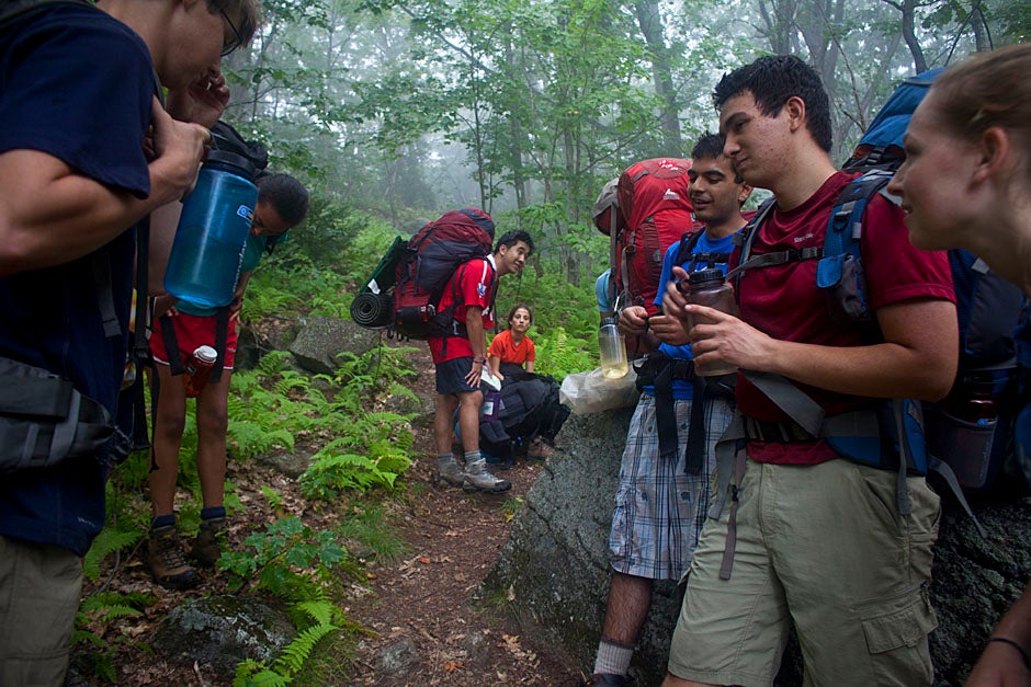 Trip leader Henry Yin '11 (center) talks to the group during a brief water stop on the trail. Justin Ide/Harvard Staff Photographer