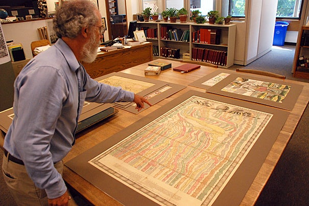 Research librarian Joseph Garver examines an early 18th century chart depicting various empires in a “river of time.”