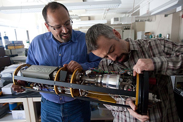 Peter Girguis (left), John L. Loeb Associate Professor of the Natural Sciences, and research scientist Scott Wankel work with an underwater mass spectrometer for analyzing gases.