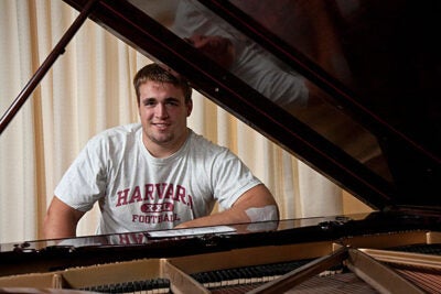 Despite weighing in at a hefty 280 pounds, Chris LeRoy '11, starting center on the Harvard football team, has a delicate touch when he's playing the music of Billy Joel or Ray Charles on the piano.
Jon Chase/Harvard Staff photographer