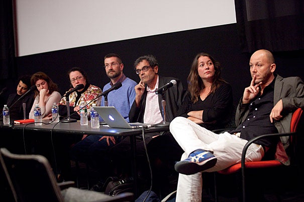 Artists Wael Shawky (from left), Lamia Joreige, Peggy Ahwesh, William E. Jones, Harun Farocki, moderator Antje Ehmann, and Kota Ezawa participate in a panel discussion on the question of how wars of the present and the experience of war can be adequately represented.
