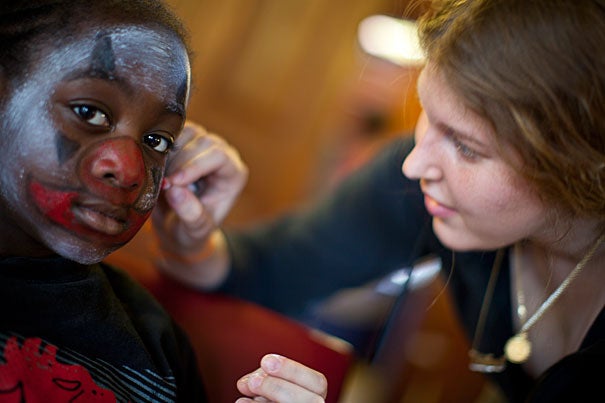 Seven-year-old DJ Pate of Boston has his face painted by PBHA's Kathryn Wilcox '11.
