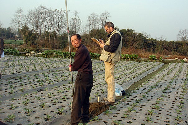 Associate Professor of Anthropological Archaeology Rowan Flad (right) conducts an auger survey during the 2009-10 season. Survey techniques commonly used by archaeologists aren’t useful in the Chengdu Plain because surface materials are obscured by the ongoing agricultural uses of the land. Team members must drill 2-meter-deep survey holes at regular intervals with hand augers.