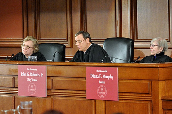 Julia Smith Gibbons (from left) of the United States Court of Appeals for the Sixth Circuit, U.S. Supreme Court Chief Justice John G. Roberts Jr. ’76, J.D. ’79, and Diana E. Murphy of the United States Court of Appeals for the Eighth Circuit preside over the final of the rigorous Ames Moot Court Competition at Harvard Law School.