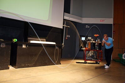 Guest speaker Howard Stone (right) demonstrates a standing wave during a lecture titled “Good Vibrations: How We Communicate,” which was hosted by Harvard’s School of Engineering and Applied Sciences. 