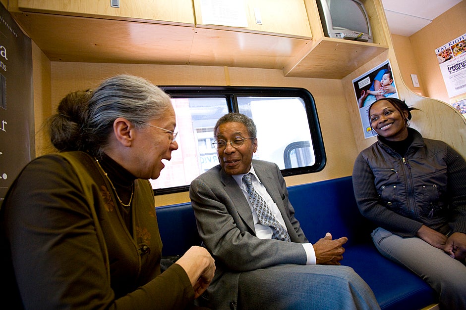 April 24, 2009. The Family Van travels throughout the city of Boston providing basic medical attention to underserved communities in the metro-Boston area including Dorchester, Hyde Park, Mattapan, and Roxbury. Harvard Medical School’s Nancy Oriol (from left) and Alvin Poussaint speak to Sandra Moreno, who translates for clients from Cape Verde and works for WIC. Photo by Stephanie Mitchell/Harvard Staff Photographer