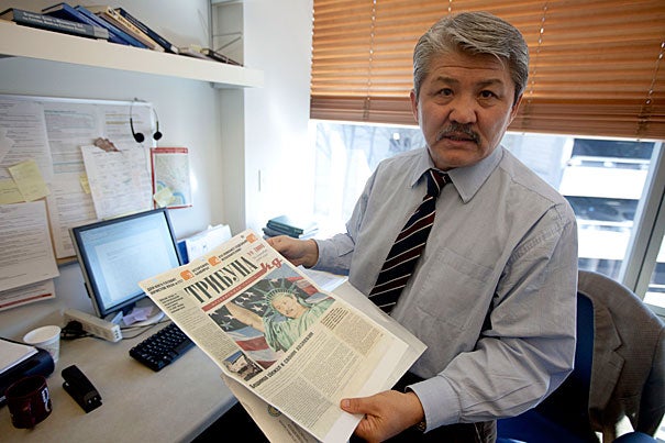 Historian Baktybek “Bakyt” Beshimov, a 2010-2011 fellow in Harvard’s Scholars at Risk program, holds a newspaper from his native Kyrgyzstan in his office at the Davis Center for Russian and Eurasian Studies. It featured him dressed as the Statue of Liberty — a “spy for the West” — at a time when his opposition political views put his life at risk.