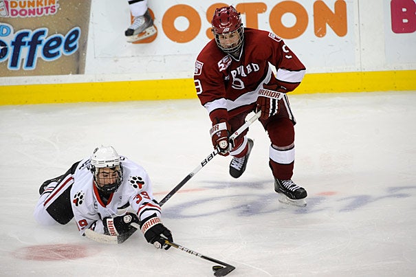 Crimson defenseman Danny Biega '13 races to the puck during the opening round of the Beanpot Hockey Tournament this year.