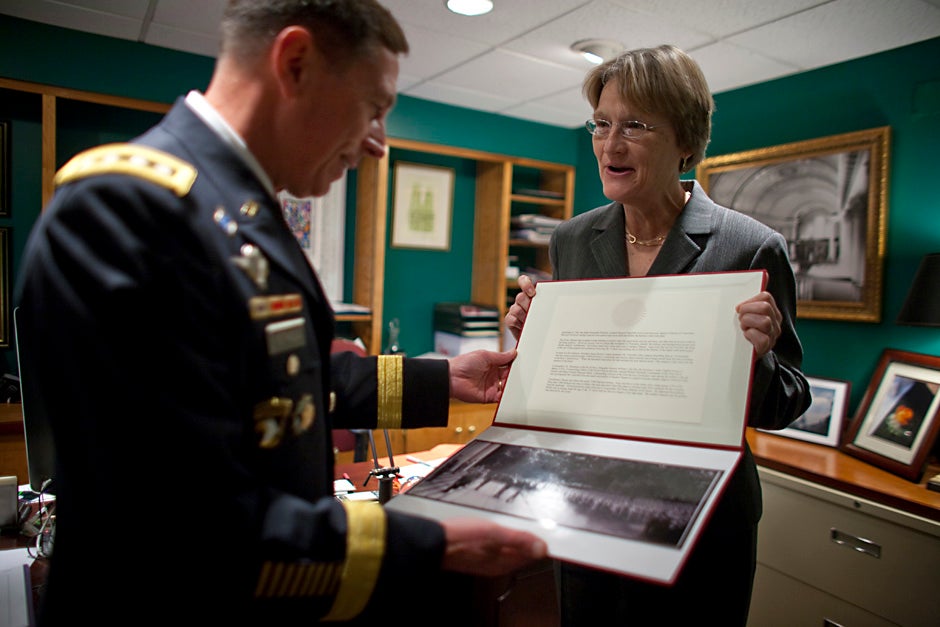 Harvard President Drew Faust presents Gen. David H. Petraeus with a historical photo of Winston Churchill speaking on the steps of Memorial Church to military officers after World War II. Petraeus spoke at the 2009 ROTC commissioning ceremony. Justin Ide/Harvard Staff Photographer