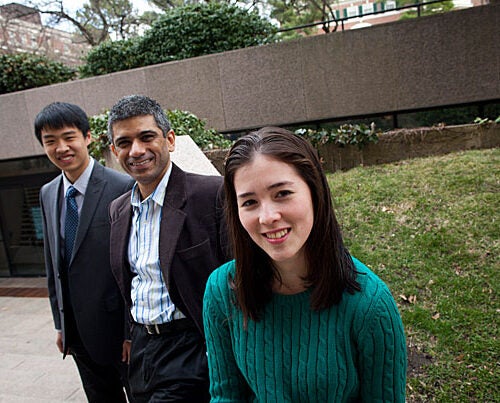 Annie Ryu (forefront) and Brandon Liu (far left) participated in a student project using text messaging to remind mothers in developing world countries about prenatal care. S.V. Subramanian (center) is their faculty adviser. 
