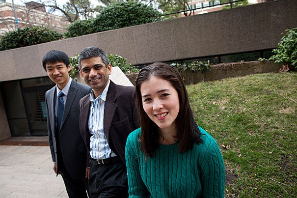 Annie Ryu (forefront) and Brandon Liu (far left) participated in a student project using text messaging to remind mothers in developing world countries about prenatal care. S.V. Subramanian (center) is their faculty adviser. 