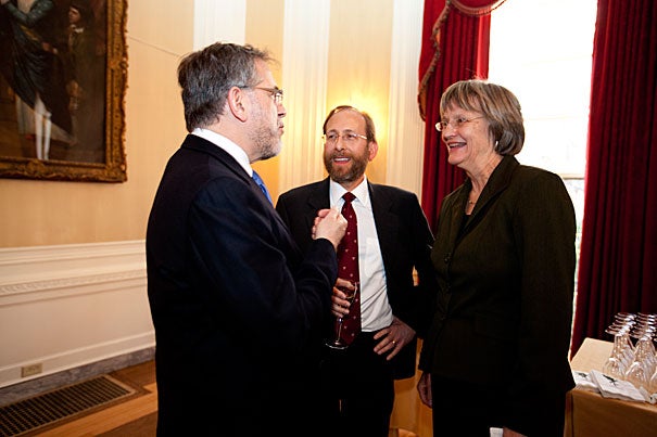 Outgoing Provost Steven E. Hyman (from left), incoming Provost Alan M. Garber, and President Drew Faust chat at a Loeb House reception held in Garber's honor. Garber's appointment is effective Sept. 1 .