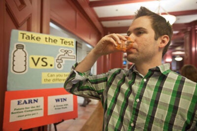 Harvard Business School student Eric Hepfer participates in the Green Living program’s Tap vs. Bottled Water Tasting Challenge. Photo by Kris Snibbe/Harvard Staff Photographer