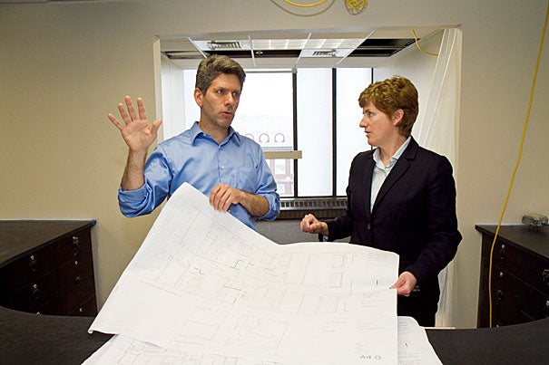 Architect Ted Galante looks at blueprints with Vice President for Campus Services Lisa Hogarty at the Campus Service Center on the 8th floor of Holyoke Center, which is currently under construction, and will combine the Parking Office, ID Services, and Harvard University Housing all in one location. 
