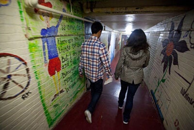 Passersby walk through the colorful Adams House tunnels.