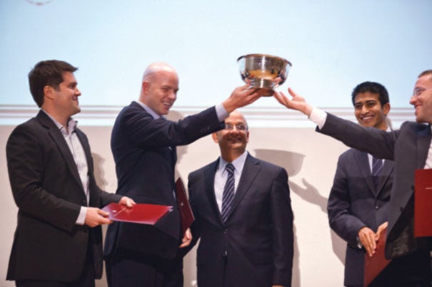 Harvard Business School Dean Nitin Nohria (center) presents Business Track awards for projects by HBS students Kimball Thomas (from left), Davis Smith, Romish Badani, and Haim Gottfried during the Harvard Business School's 15th annual Business Plan Contest in Burden Hall.