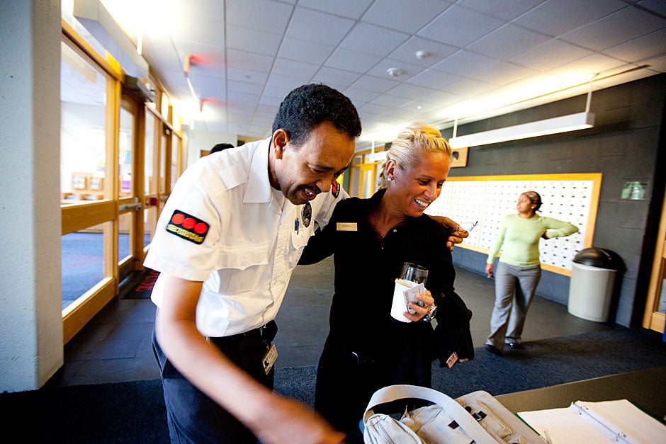 Patricia Machado (right) works in Dining Services at Currier House and is welcomed to work by Yohannes Tewolde. Rose Lincoln/Harvard Staff Photographer