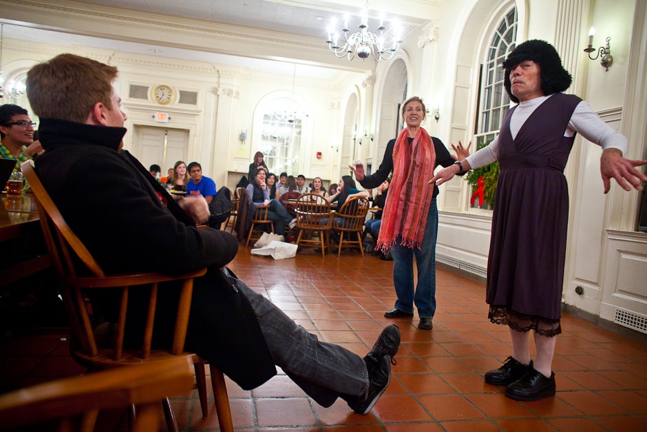 Senior Mark Isaacson (left) watches a “Secret Santa” skit performed by House Masters Tom (right) and Verena Conley (center) inside the dining hall at Kirkland. Secret Santas have others perform amusing or embarrassing skits for their selected person all week during lunch and dinner at Kirkland. Justin Ide/Harvard Staff Photographer
