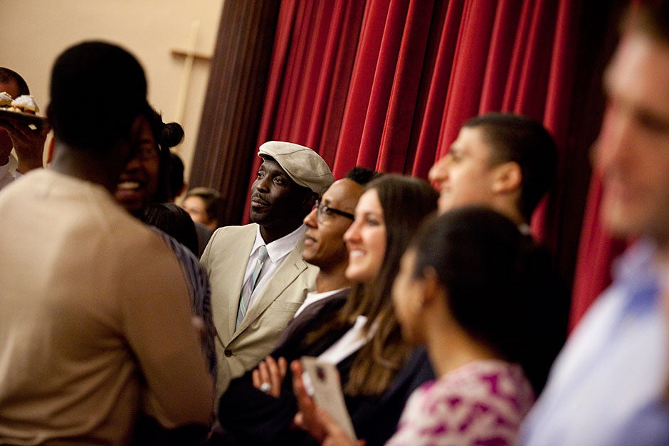 Michael K. Williams (center, in hat) and Andre Royo (in glasses), the actors who played Omar and Bubbles, respectively, speak to the gathered guests following the dinner. Stephanie Mitchell/Harvard Staff Photographer