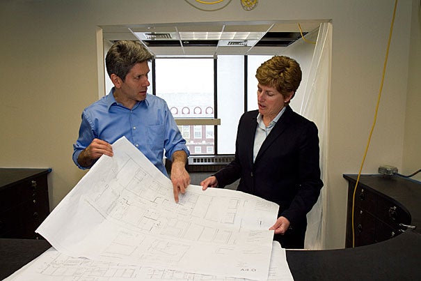 Ted Galante (left), an architect with Galante Architectural Studios, reviewed blueprints for the Campus Services Center back in May with Vice President for Campus Services Lisa Hogarty. The center is now open on the eighth floor of Holyoke Center. 