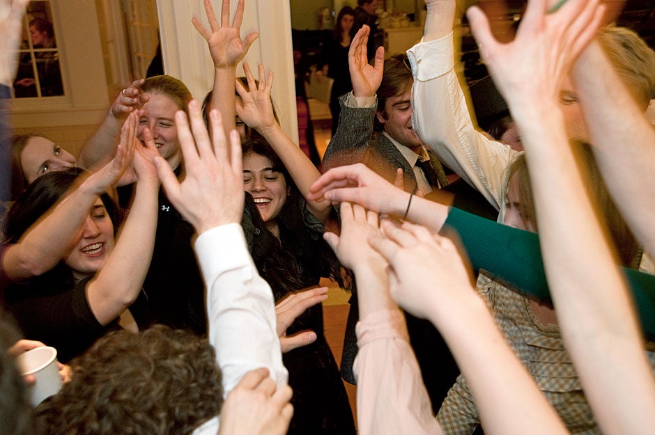 In a show of camaraderie, Dunster House Opera Society members raise hands in a group salute before going onstage to perform Johann Strauss’ “Die Fledermaus.” Jon Chase/Harvard Staff Photographer