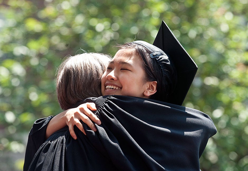 Susan Zhu '11 gets a congratulatory hug from Dunster House Co-Master Ann Porter at the House diploma ceremony on Commencement day. Jon Chase/Harvard Staff Photographer