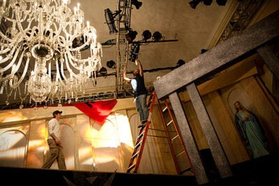 A behind-the-scenes look at the Lowell House Opera. Stage manager Chad Andrew Burn (from left) and set designer Mark Buchanan prep the lighting before the dress rehearsal of Puccini's "Tosca."