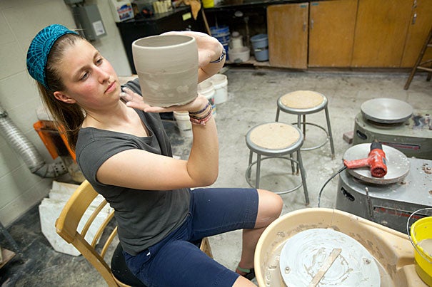 Caroline Lowe '12 works in the Mimi Aloian Pottery Studio.