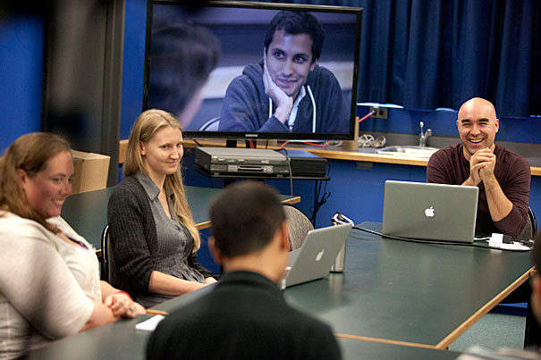 Bok Center coordinator Shelley Westover (from far left) and teaching fellow Anita Nikkanen join Bok Center Associate Director Marlon Kuzmick (shaved head) as he teaches a class about multi-modal communication and how it can be used in the classroom. GSAS health policy student Ankur Pandya is seen on the monitor practicing his teaching methods. 