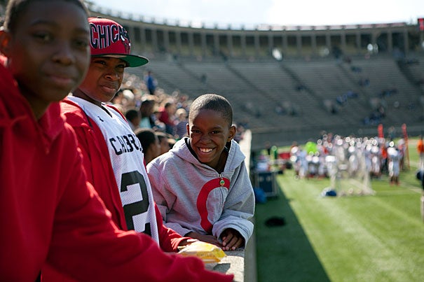 Taking part in Harvard's annual Community Football Day were (from left) Jamal Peters, 13, Kyree Johnson, 12, and Saheim Jackson, 8. The Cambridge youngsters were among the 1,000 or so community residents invited to the Crimson football game on Oct. 15. 