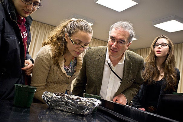 Earthworms took center stage at John Knowles Paine Hall last month as students in a freshman seminar re-created Darwin’s experiment exploring the creature's hearing. Arnold Professor of Organismic and Evolutionary Biology Ned Friedman (third from left) and students peer at worms to see if they are responding to sounds, below, the stars of the show.