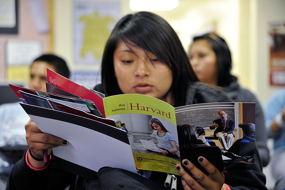 A Native American student at Bernalillo High School looks over a Harvard brochure. The fact that Harvard waives tuition entirely for families earning less than $65,000 makes it a more viable option than the University of New Mexico or even a local tribal college for low-income families. Jon Chase/Harvard Staff Photographer