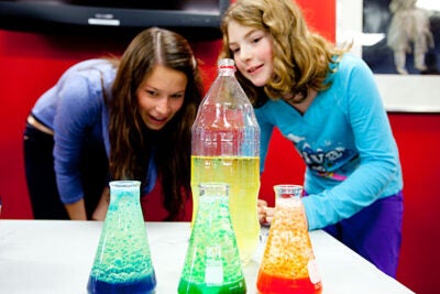 Andrea Henricks ’13 (left), a mentor at the Harvard Allston Education Portal, and 10-year-old Nora Lyons made lava lamps, which they presented at a Student Showcase and Open House. The Harvard mentoring program pairs Allston-Brighton children in grades one to 12 with Harvard undergraduates in weekly sessions throughout the semester.