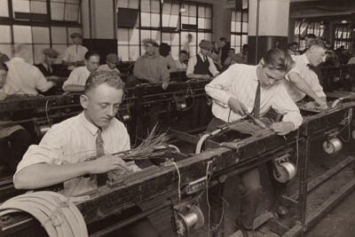 In 1924, Western Electric began conducting experiments to test ways of improving workers’ productivity. This photo shows the factory cabling department, ca. 1925. The experiments would eventually revolutionize the workplace.