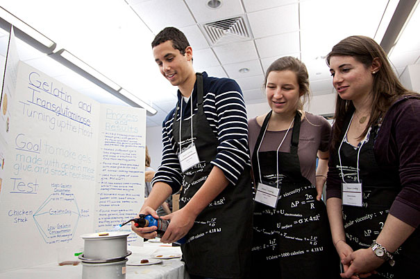 Gashaw Clark ’14 (from left), K. Lanier Walker ’14, and Rebecca Ruskin ’13 prove that their jellied meat stock is stable enough to withstand direct flame without melting. 