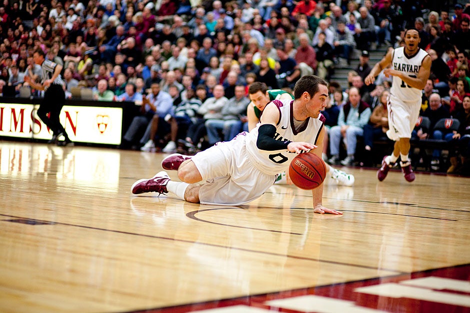 Harvard’s Laurent Rivard looks around for help as he dribbles on his knees after grabbing a loose ball — and eluding the whistle.  Rose Lincoln/ Harvard Staff Photographer