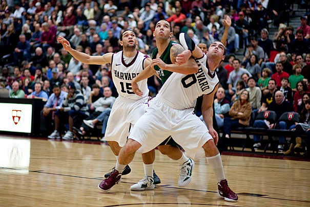 Harvard's Laurent Rivard (right) and Christian Webster (left) sandwich an opponent in pursuit of the rebound in a game against Dartmouth College on Jan. 7. The Crimson won 63-47. 