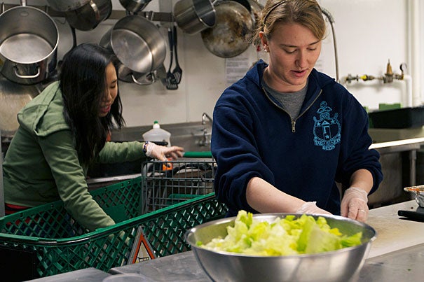 “As a volunteer at the Harvard Square Homeless Shelter, I feel like I’m doing something with a very tangible impact,” said Janie Tankard '12 (right).  Fellow volunteer Jennifer Soong '14 (left) and Tankard  prepare dinner for their guests. 