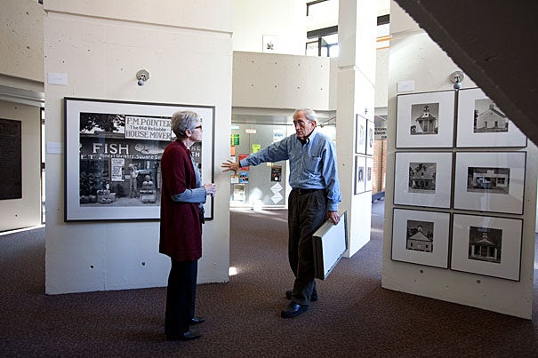 Mather House Master Christie McDonald (left) discusses the latest exhibit with John T. Hill. Hill designed and produced “Walker Evans: Before and After the FSA," which is on view at Mather House's SNLH Three Columns Gallery.