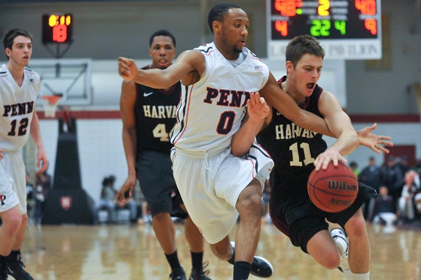 Harvard's Oliver McNally '12 (right) encounters some tough Penn defense as he drives toward the basket.
