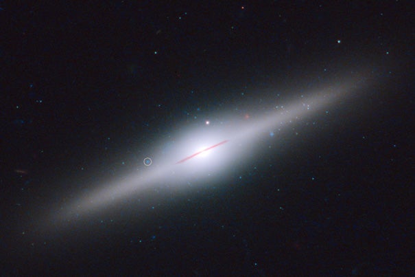 This spectacular edge-on galaxy, called ESO 243-49, is home to an intermediate-mass black hole that may have been stripped off of a cannibalized dwarf galaxy.
