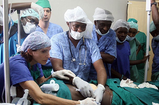 Vicki Modest (far left) demonstrates the use of ultrasound in the operating room to Sadic Kagwa, an anesthesia resident at Mbarara. "Pain control is one of the major issues before and after an operation," said Paul First, assistant professor of anesthesia at Harvard Medical School. 