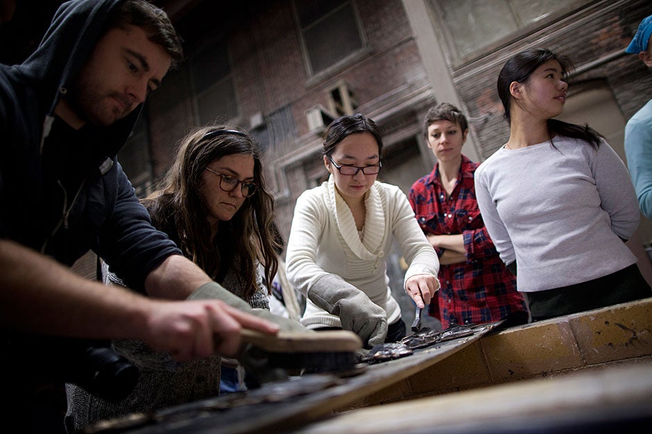 The workshop aimed to introduce students to bronze casting from multiple perspectives. Here the students had the opportunity to create their own bronze sculptures. Art history graduate students Daniel Zolli (from left), Marisa Mandabach, and Bing Huang are busy at work. Graduate student Jordan Troeller and Michelle Chang '15 look on. Stephanie Mitchell/Harvard Staff Photographer
