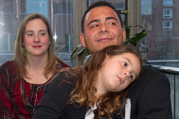 Ronaldo Antunes (right) was among the 23 Harvard staff members who celebrated their U.S. citizenship. Antunes was joined by his daughter Madeleine, 7, and wife Michele.