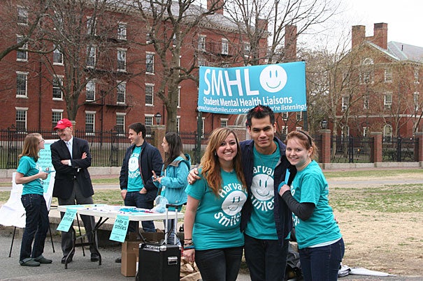 Student Mental Health Liaisons (SMHL) Jem Lugo '13 (from left), Francisco Hernandez '13, and Meghan Smith '13 huddle at the inaugural Rally for Smiles last April. More than 700 members of the Harvard College community signed the SMHL pledge to “be aware of the resources available for well-being at Harvard and to be an advocate for mental health on campus.” This year’s rally will take place on April 18 on the Science Center Plaza.